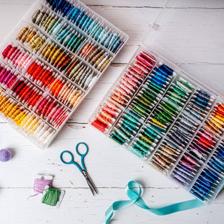 Cross stitch thread stored in bobbin storage boxes