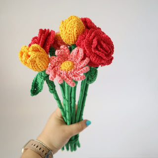 Person holding bouquet of crochet flowers