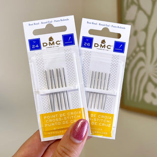 Two packets of DMC cross stitch needles in sizes 24 and 26