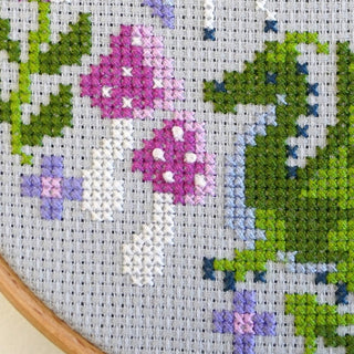 Mythical fantasy themed cross stitch design with french knot details