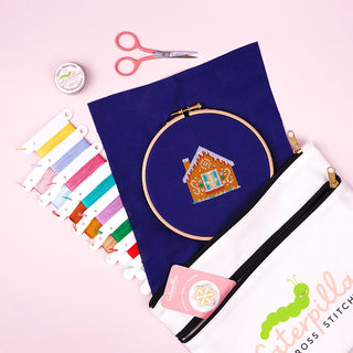 Gingerbread Lane Stitch-a-long stitched sneak peek sample with needle minder, thread wax, scissors and double pocket project bag