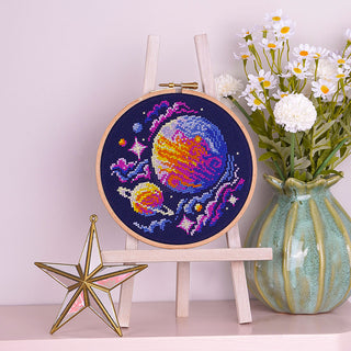 Out of this World Cross Stitch Kit - Stitched sample in 6inch Elbesee hoop on mantelpiece 
