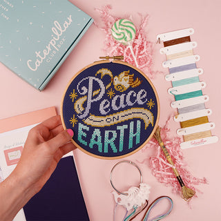 Peace on Earth Caterpillar Club Box sample in hand