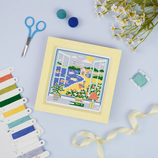 Summer View stitched sample in frame with accessories